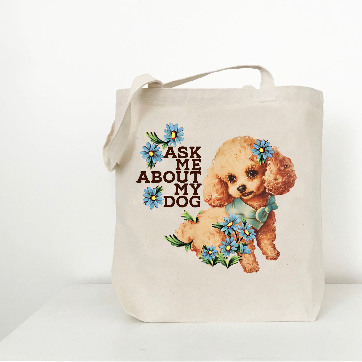 Tote bag with a dog illustration and “Ask me about my dog” text on a beige background