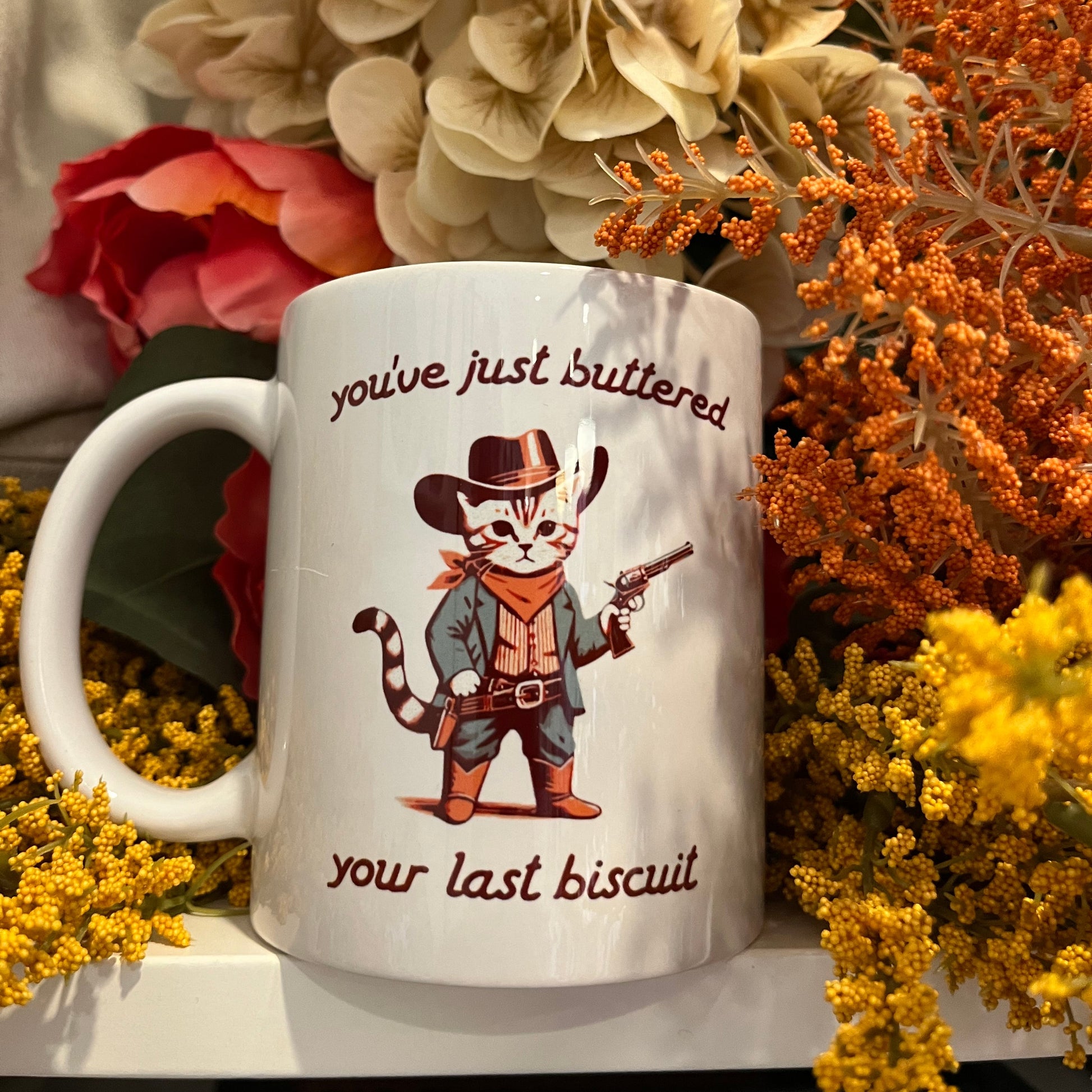 Mug with cowboy cat illustration Buttered your last biscuit text 