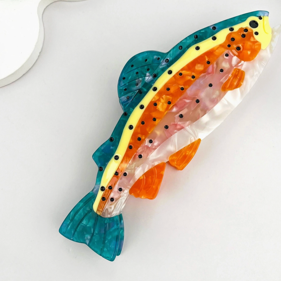 Colorful trout hair claw clip on a white background