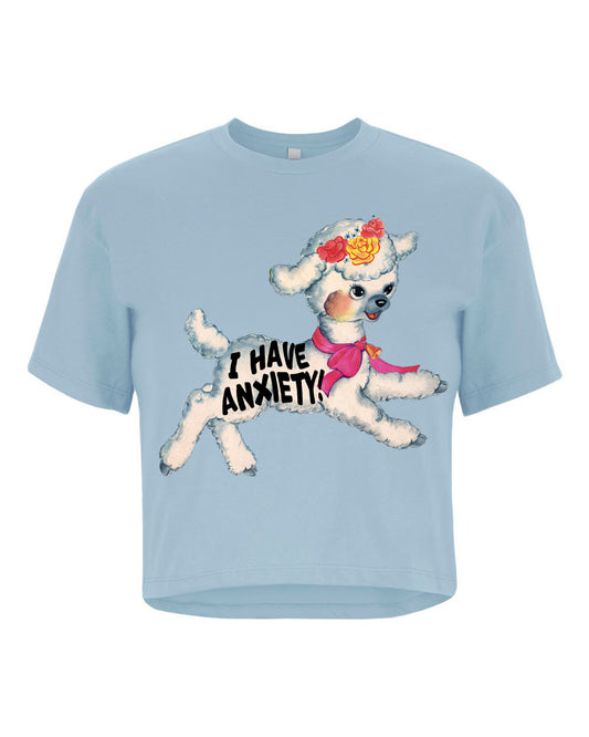 Light blue crop t-shirt with a cartoon sheep wearing a pink bow and flower crown, and 'I have anxiety!' text.