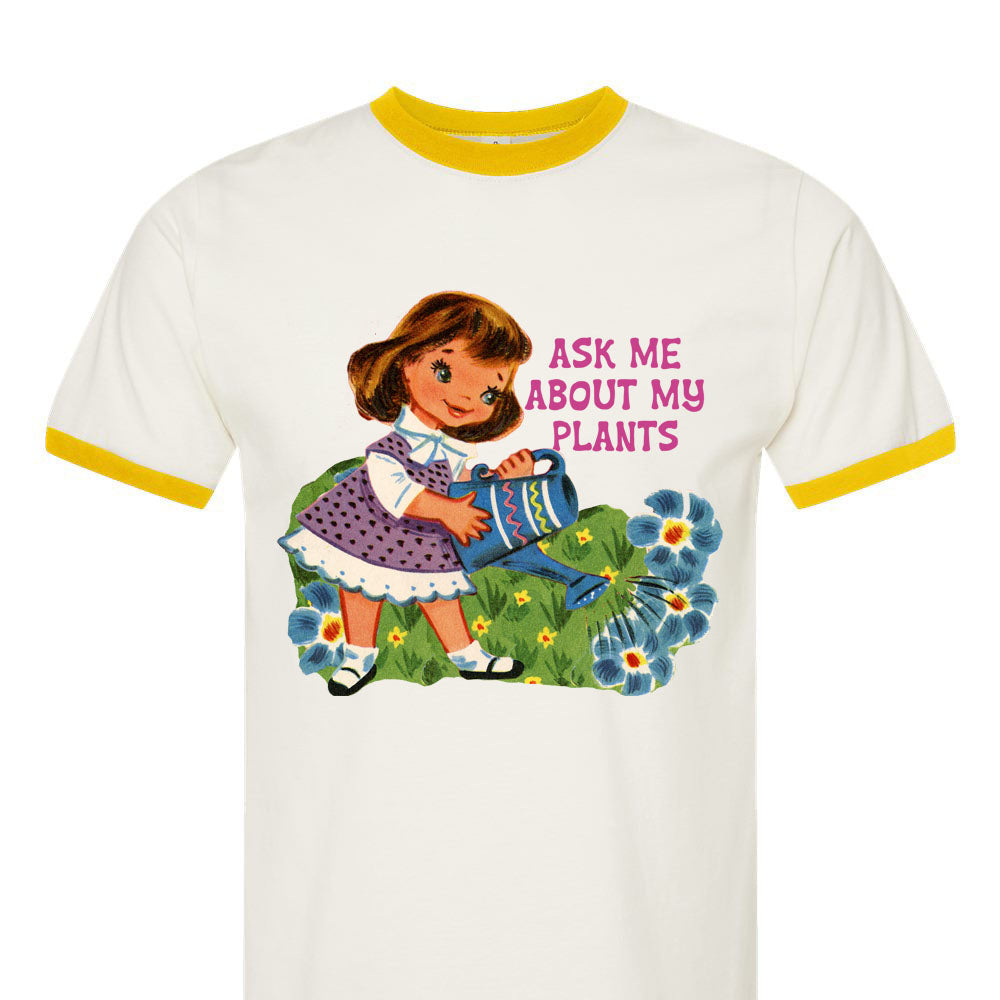 White t-shirt with a graphic of a girl and flowers, and text 'Ask me about my plants'.