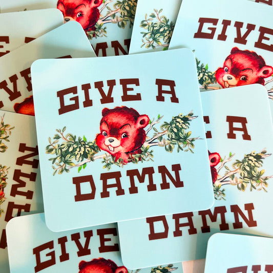 Stickers with beaver illustration and 'Give a Damn' text on light blue background