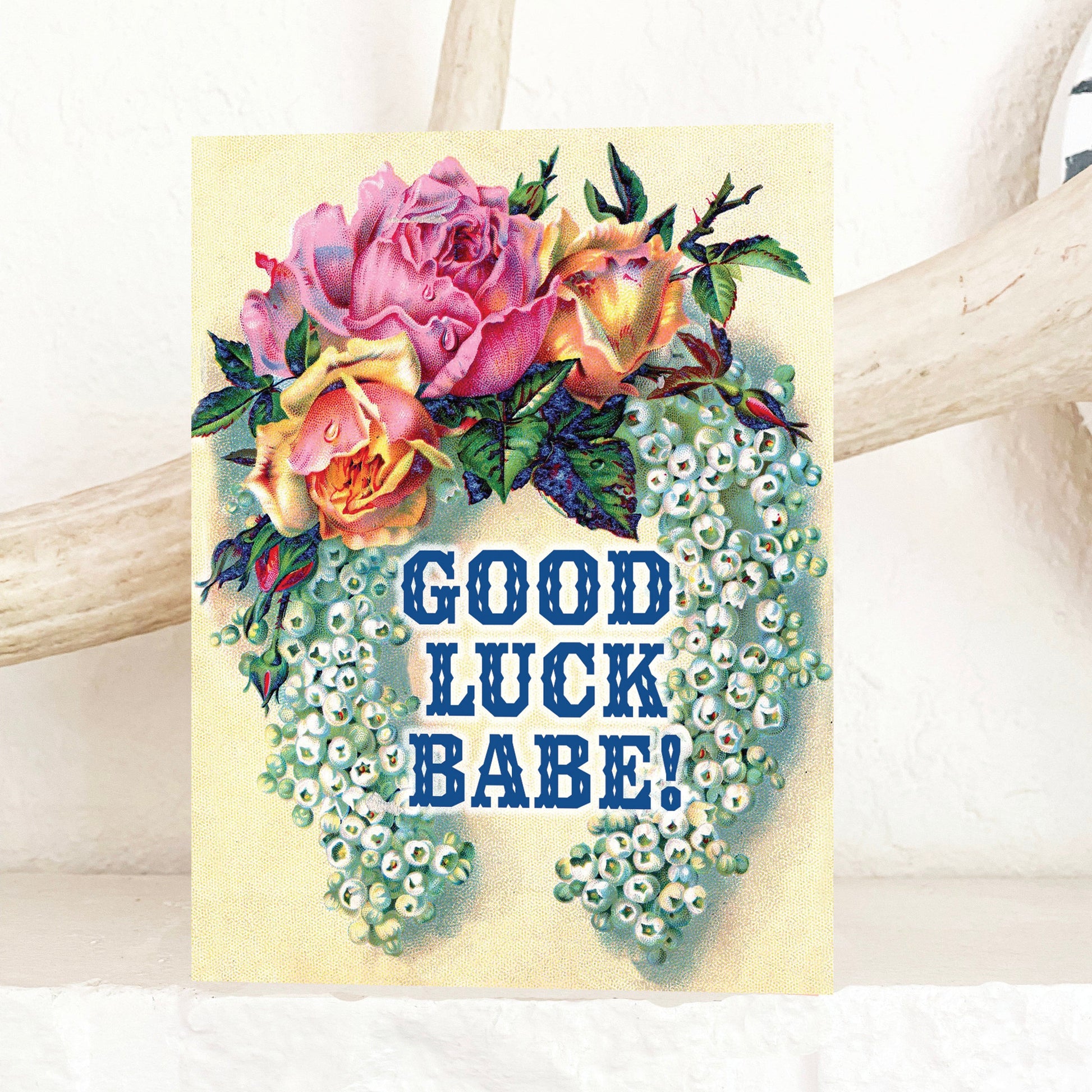 Card with floral design and 'Good Luck Babe!' text on a cream background