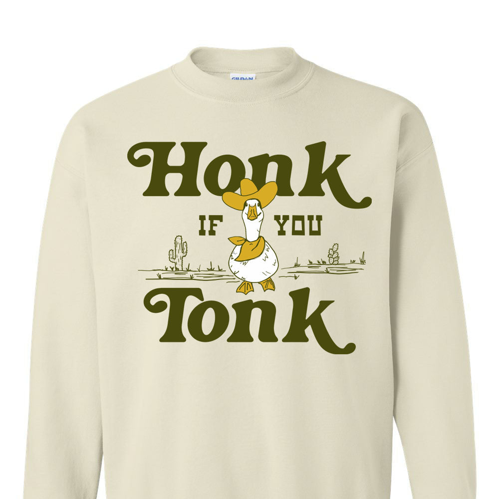 Beige sweatshirt with a graphic of a duck and text 'Honk if you Tonk' on a white background