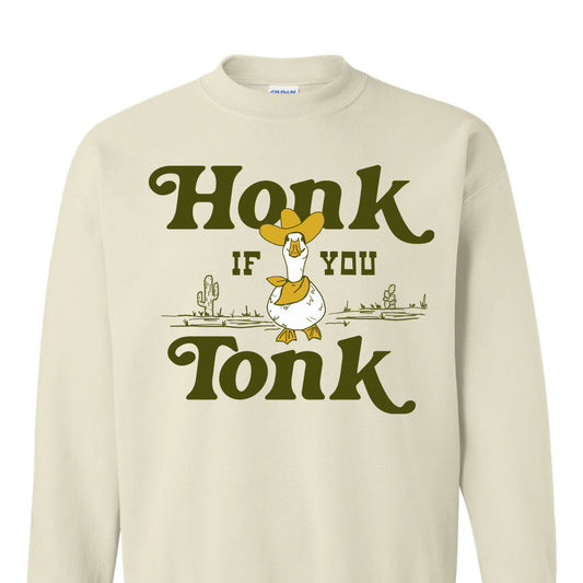 Beige sweatshirt with a graphic of a duck and text 'Honk if you Tonk' on a white background