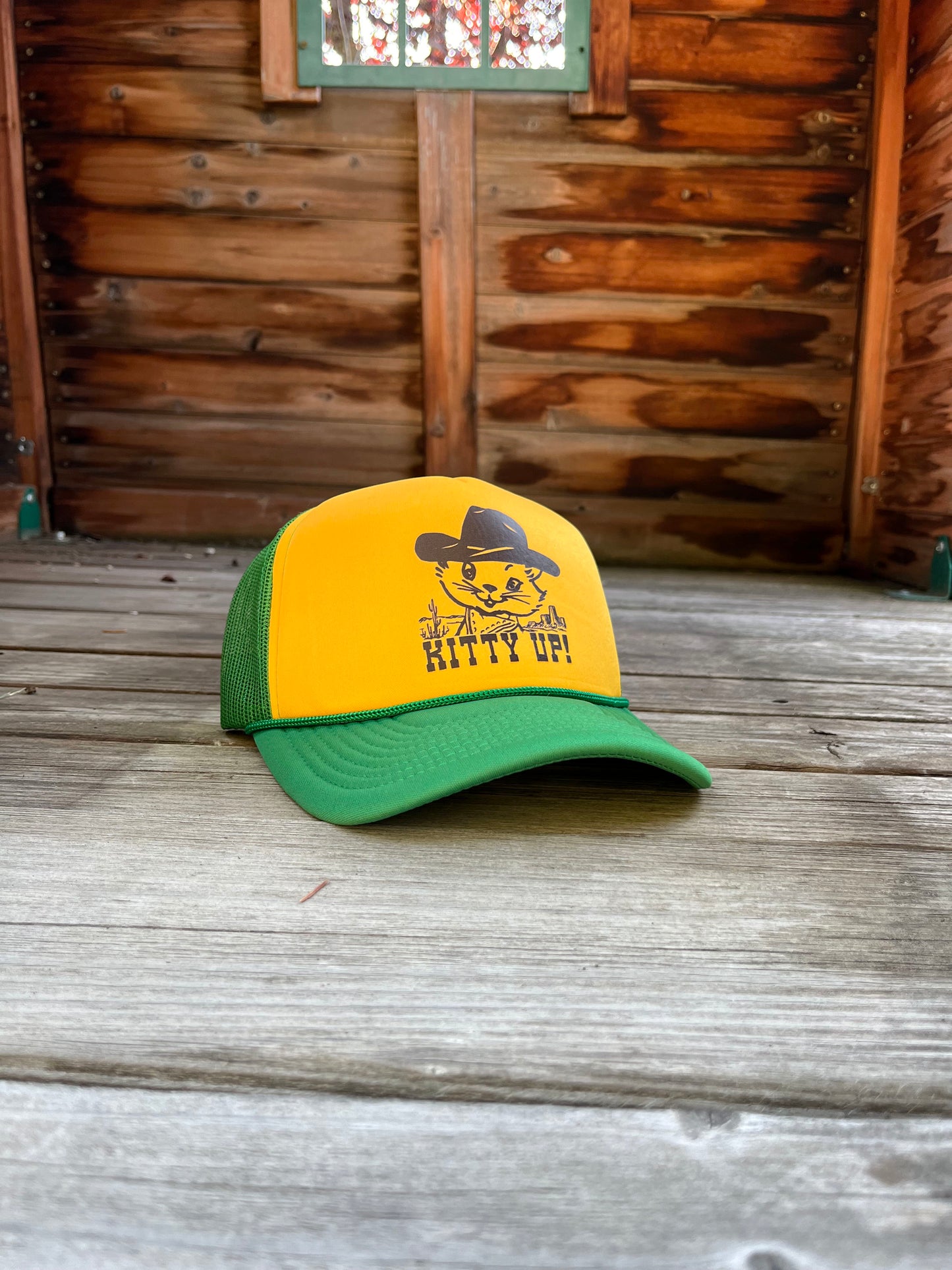 Yellow and green cap with a cat graphic and 'Kitty Up!' text