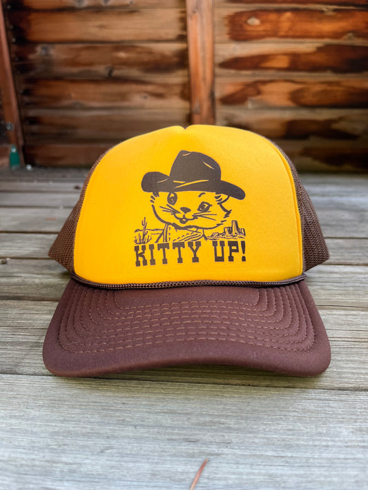 Yellow and brown trucker hat with a cat graphic and 'Kitty Up!' text.