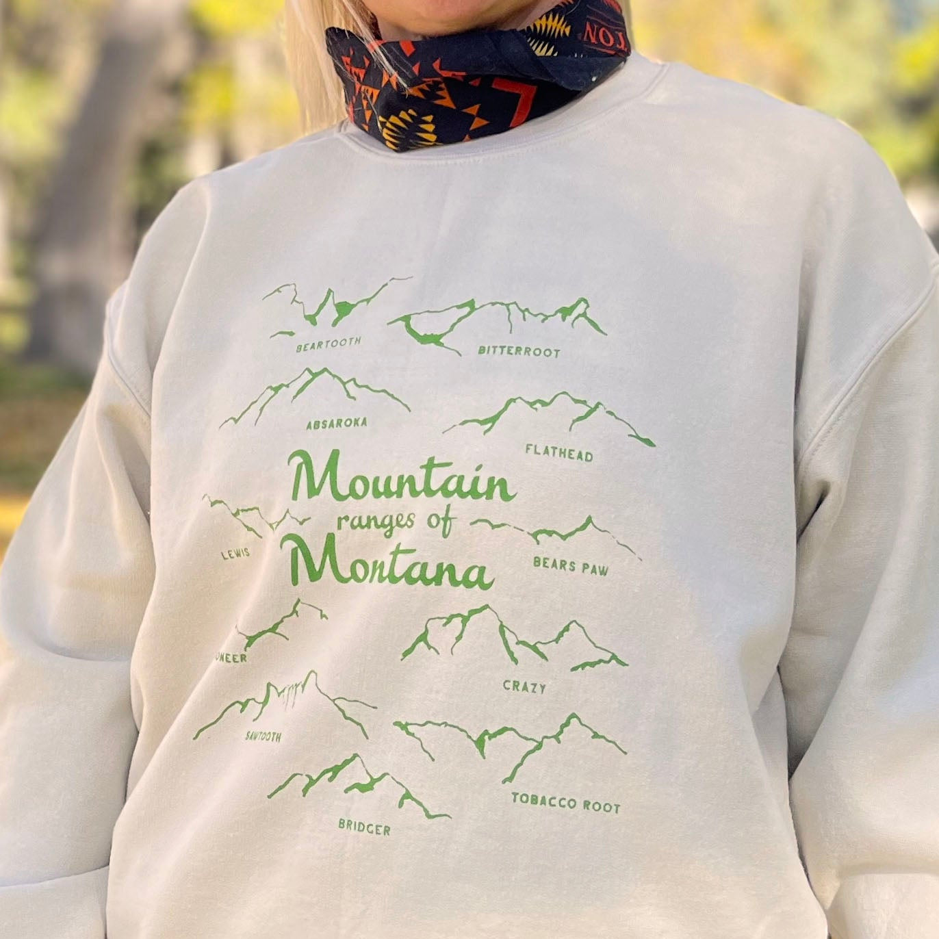 Mountain ranges of montana crew neck sweatshirt cream with green screen print bridger bozeman big sky missoula yellowstone glacier souvenir skier hiker adventure western fashion style hb elliot