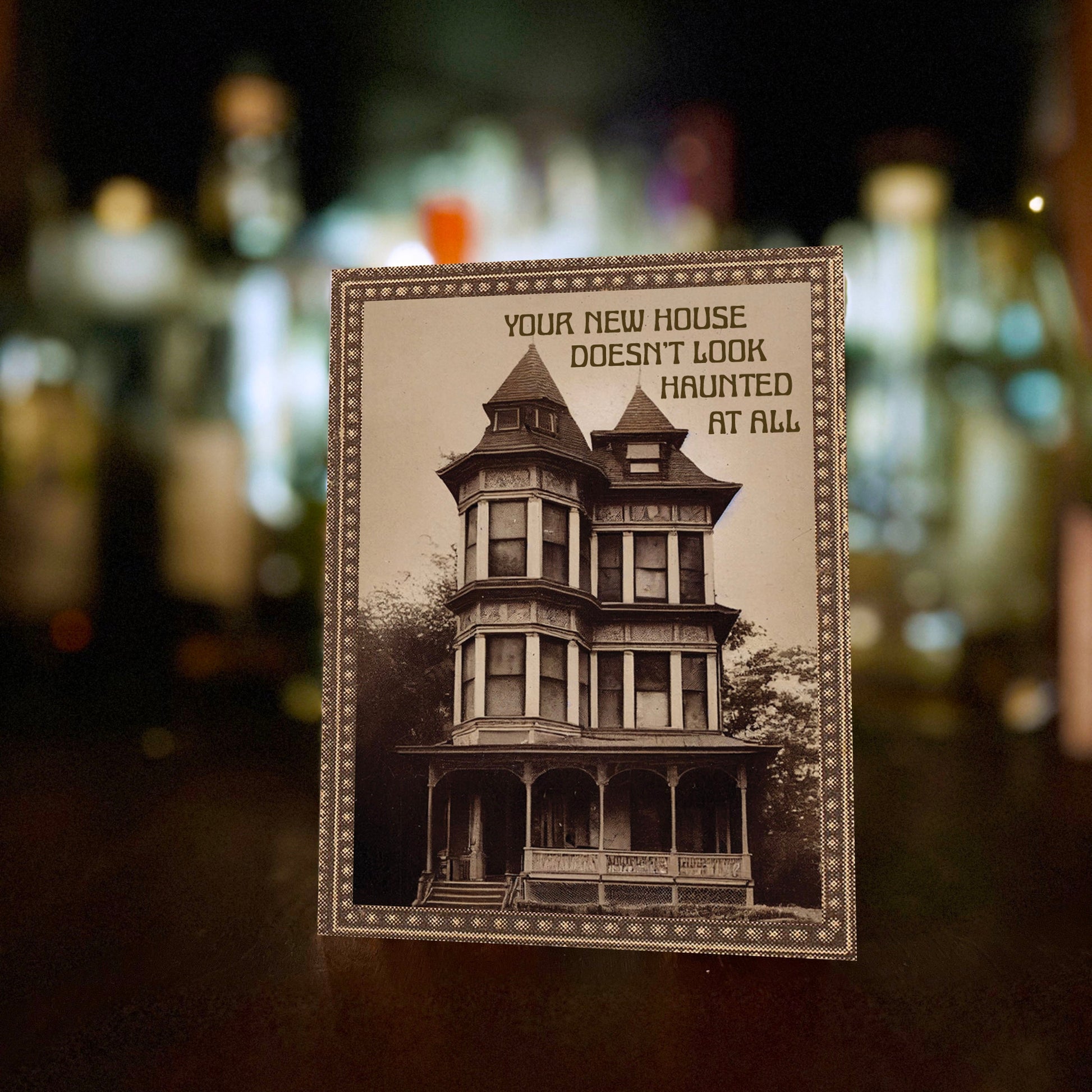 Card with vintage-style house illustration with “Your new house doesn’t look haunted at all” text.