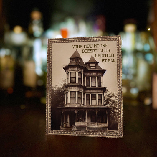 Card with vintage-style house illustration with “Your new house doesn’t look haunted at all” text.