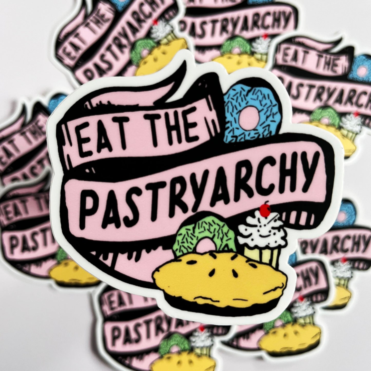 funny vinyl sticker says eat the pastryarchy joke anti patriarchy feminist baked goods fun sticker decal coin laundry montana