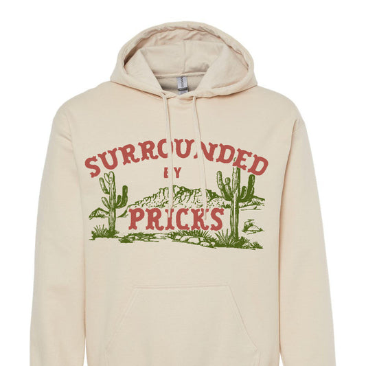 Beige hoodie with graphic design and surrounded by pricks text on a white background