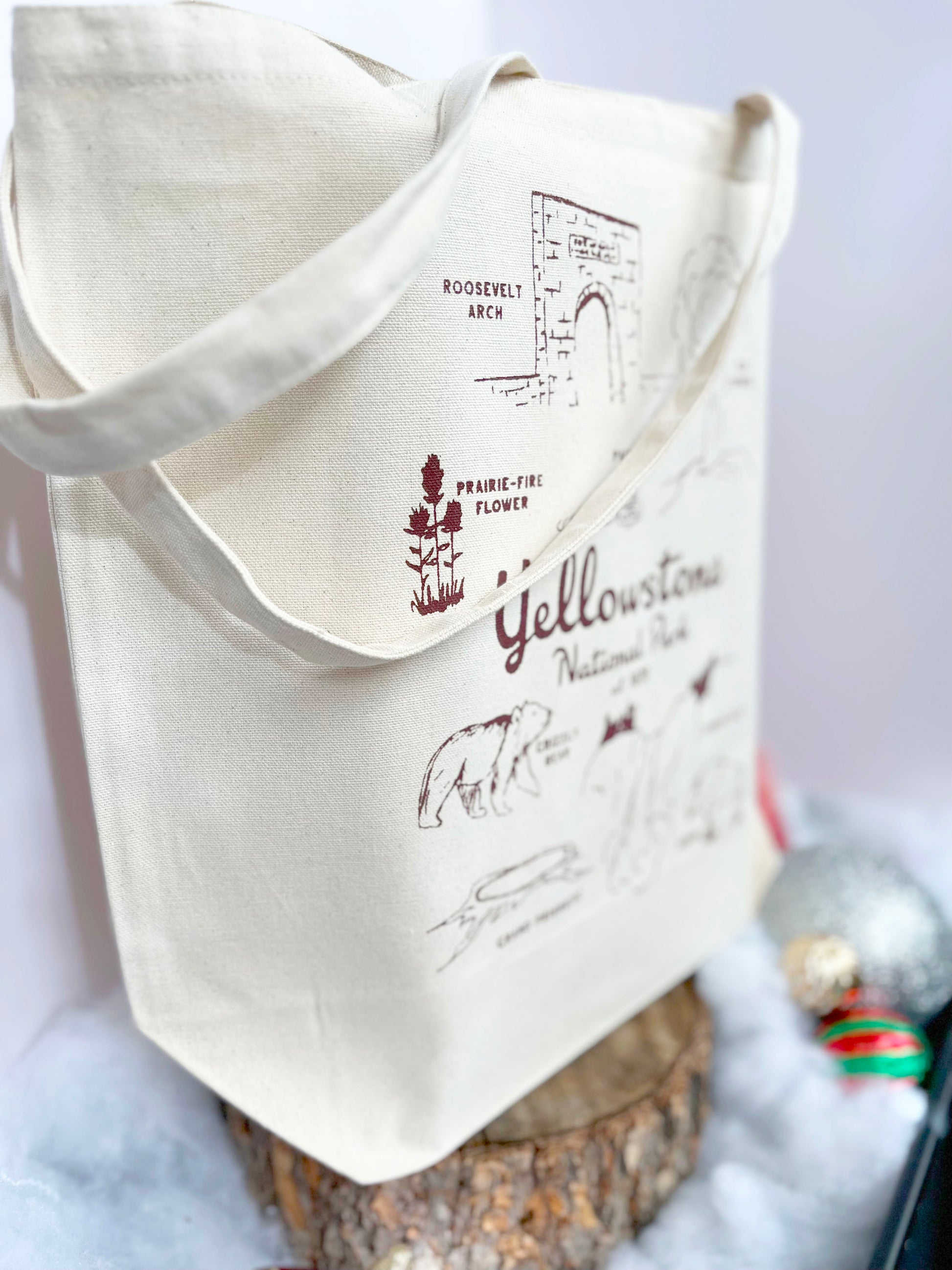 Tote bag with Yellowstone National Park illustrations and text on a white background
